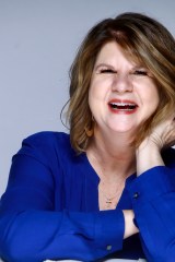 author photo of woman author laughing in blue shirt